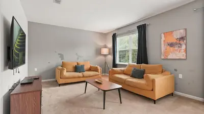 a living room with two chairs and a table at Summer Sale - Beautiful 6BR Home with Private Pool! in Kissimmee