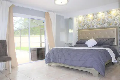 a bedroom with a bed and a large window at Wonderful Villa with swimming pool, near Orlando attractions in Kissimmee
