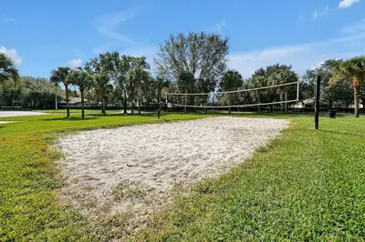 a volley ball net in a park with grass at Personally Designed Home w/ Pool, Game Room near Disney in Orlando