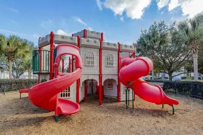 a playground with a red slide in front of a building at Personally Designed Home w/ Pool, Game Room near Disney in Orlando
