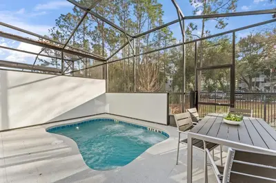 a swimming pool with a table and chairs and a table and a tablektop at Lux 5BR Home, Game Room, 4 Suites & Private Pool in Orlando