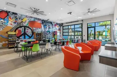 a restaurant with colorful chairs and tables and a mural at Lux 5BR Home, Game Room, 4 Suites & Private Pool in Orlando