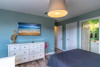 a bedroom with a white dresser and a blue wall at 2614 Veranda Palms in Kissimmee