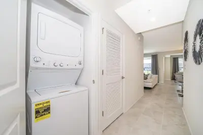 a white laundry room with a washer and dryer at 3111-102RD CONDO 2 BEDS/2 BATHS (SANITIZED) in Kissimmee