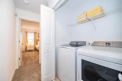 a white washer and dryer in a white room at 2585LA TOWNHOUSE 4 BEDROOMS & 3 BATHROOMS + POOL in Kissimmee