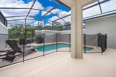 a large glass house with a swimming pool in it at 2585LA TOWNHOUSE 4 BEDROOMS & 3 BATHROOMS + POOL in Kissimmee