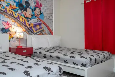 a bedroom with two beds and a painting on the wall at 4337 QS - Charming Hideaway in Kissimmee