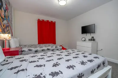 a bedroom with two beds and a flat screen tv at 4337 QS - Charming Hideaway in Kissimmee