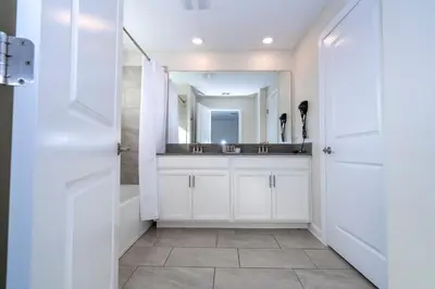 a bathroom with a sink and a mirror at 4337 QS - Charming Hideaway in Kissimmee