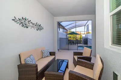 a living room with a couch and chairs and a balcony at 4435LT TOWNHOUSE 4 BEDROOMS & 3 BATHROOMS + POOL in Kissimmee
