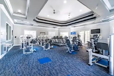 a gym with treadmills ellipticals and tread machines at Cozy Condo Minutes Away From Disney in Kissimmee