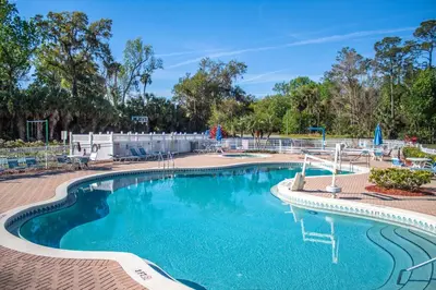 a pool at a resort with blue water at Barefoot'n Resort Kissimmee Orlando in Orlando