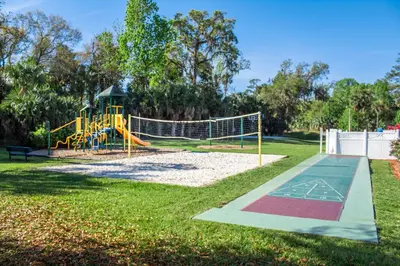 a playground with a slide in a park at Barefoot'n Resort Kissimmee Orlando in Orlando