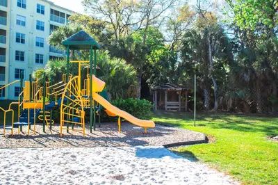 a playground with a slide in a park at Barefoot'n Resort Kissimmee Orlando in Orlando
