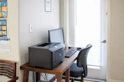 a desk with a computer and a printer on it at Barefoot'n Resort Kissimmee Orlando in Orlando