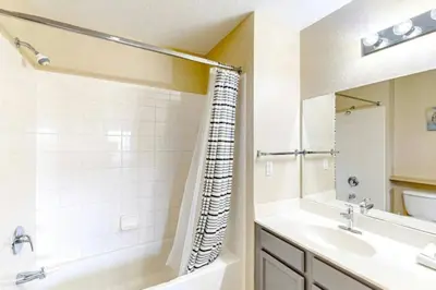 a bathroom with a tub and a sink and a shower at 4 Bedroom 3 Bathroom Villas At SevenDwarfs 12-108 in Kissimmee