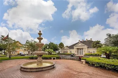 a fountain in front of a large house at 4 Bedroom 3 Bathroom Villas At SevenDwarfs 12-108 in Kissimmee