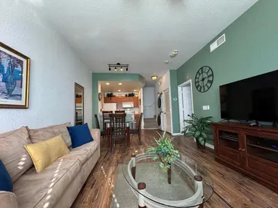 a living room with a couch and a tv at 3 Bedroom 2 Bathroom Villas At SevenDwarfs 21-103 in Kissimmee