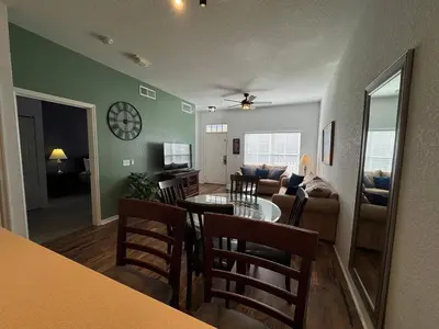 a living room with a table and a couch at 3 Bedroom 2 Bathroom Villas At SevenDwarfs 21-103 in Kissimmee