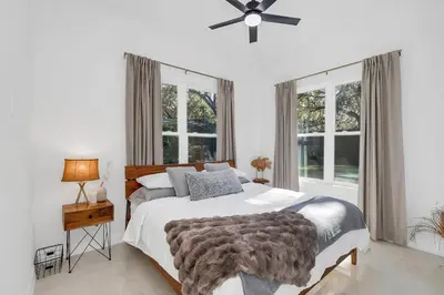 a bedroom with a bed and two windows at Florida HappyNest Secluded Luxury Guesthouse in Kissimmee