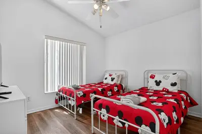 a bedroom with two beds with hello kitty sheets at Luxury 4-Bedroom Home with Private Pool, Jacuzzi, AC, Wi-Fi, Cable TV, 5 Minutes from Disney in Kissimmee