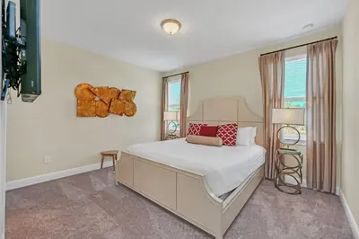 a white bedroom with a bed and a window at Luxe Family Escape at Encore at Reunion in Orlando