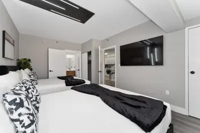 a bedroom with two beds and a flat screen tv at Cozy Orlando Getaway with Pool Access in Orlando