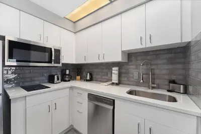 a kitchen with white cabinets and a sink at Cozy Orlando Getaway with Pool Access in Orlando