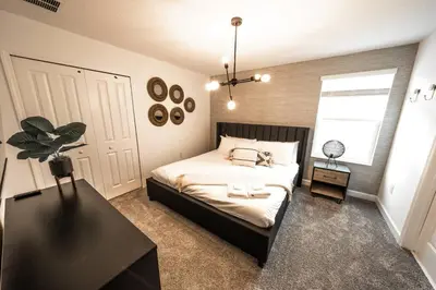 a bedroom with a bed and a potted plant at Dream Vacation Home with Lake View, Pool, more, and Walking Distance to Resort in Kissimmee