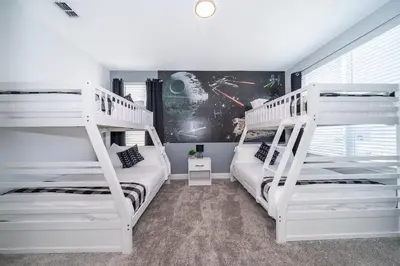 two white bunk beds in a room with a window at 4338JE VILLA 5 BED/5 BA in Kissimmee