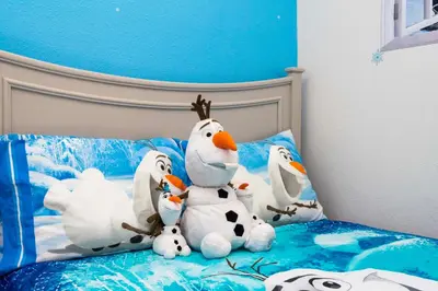a group of stuffed animals sitting on a bed at happy place in Kissimmee