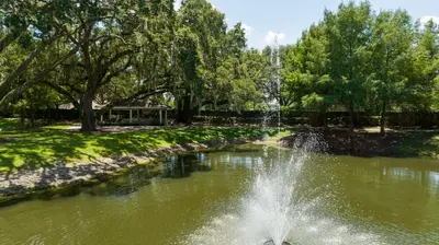 a fountain in a pond in a park at happy place in Kissimmee