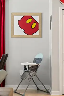 a chair in a room with a picture on the wall at Lakeview 5BR with Game Room and Pool, Near Disney in Kissimmee