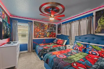 a bedroom with two beds and a ceiling fan at Lakeview 5BR with Game Room and Pool, Near Disney in Kissimmee