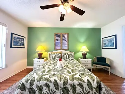 a bedroom with a bed and a ceiling fan at 10 Min from Disney Themed 2 Bd Private Pool in Orlando