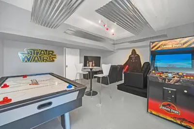 a gaming room with a star wars game and a video game console at The Ultimate Family Getaway in Kissimmee
