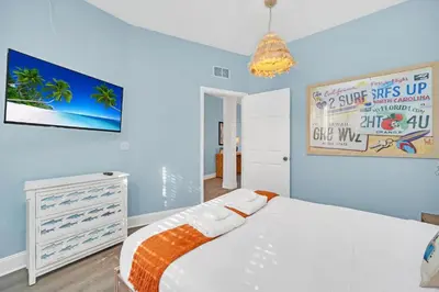 a bedroom with a white bed and a tv at The Ultimate Family Getaway in Kissimmee
