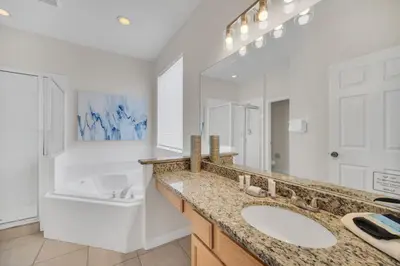 a bathroom with a sink and a tub and a toilet at The Ultimate Family Getaway in Kissimmee