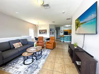 a living room with a couch and a table at Amazing! Disney 7 Min, Walmart 1 min, 3 Bed 2 bt in Orlando