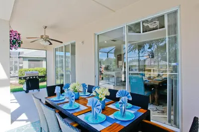 a dining room with a table with blue dishes on it at PN Orlando Vacation Home in Kissimmee