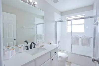 a white bathroom with a sink and a shower at PN Orlando Vacation Home in Kissimmee