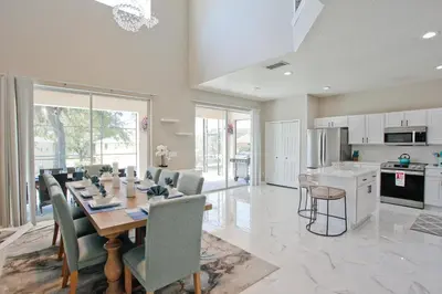 a kitchen and dining room with a table and chairs at PN Orlando Vacation Home in Kissimmee