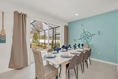 a dining room with a table and chairs at Home w Pool & Games Room Near Disney -Pet Friendly in Kissimmee