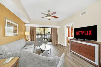 a living room with a couch and a tv at Orlando Getaway at Floridays Resort in Orlando