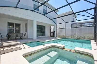 a swimming pool in a house with a glass ceiling at Spacious 6 Bed Home with Pool in Prime Storey Lake Location in Kissimmee
