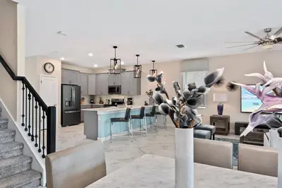 a kitchen and living room with a dining and living room at 9 Bed Home Pool Best Location Storey Lake in Kissimmee