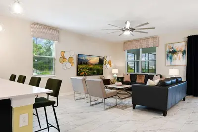 a living room with a couch and a table at 9 Bed Home Themed Rooms Pool Storey Lake in Kissimmee