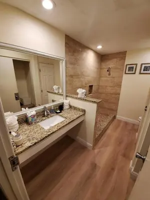 a bathroom with a sink and a large mirror at Nice 2 Miles from DISNEY Condo 1 Bedroom 1 Bath in Orlando