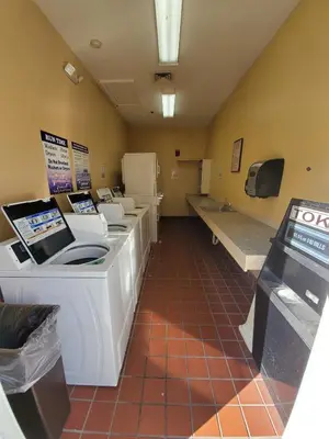 a waiting room with a row of sinks and toilets at Nice 2 Miles from DISNEY Condo 1 Bedroom 1 Bath in Orlando