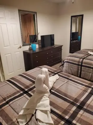 a hotel room with a bed with a robe on it at Nice 2 Miles from DISNEY Condo 1 Bedroom 1 Bath in Orlando